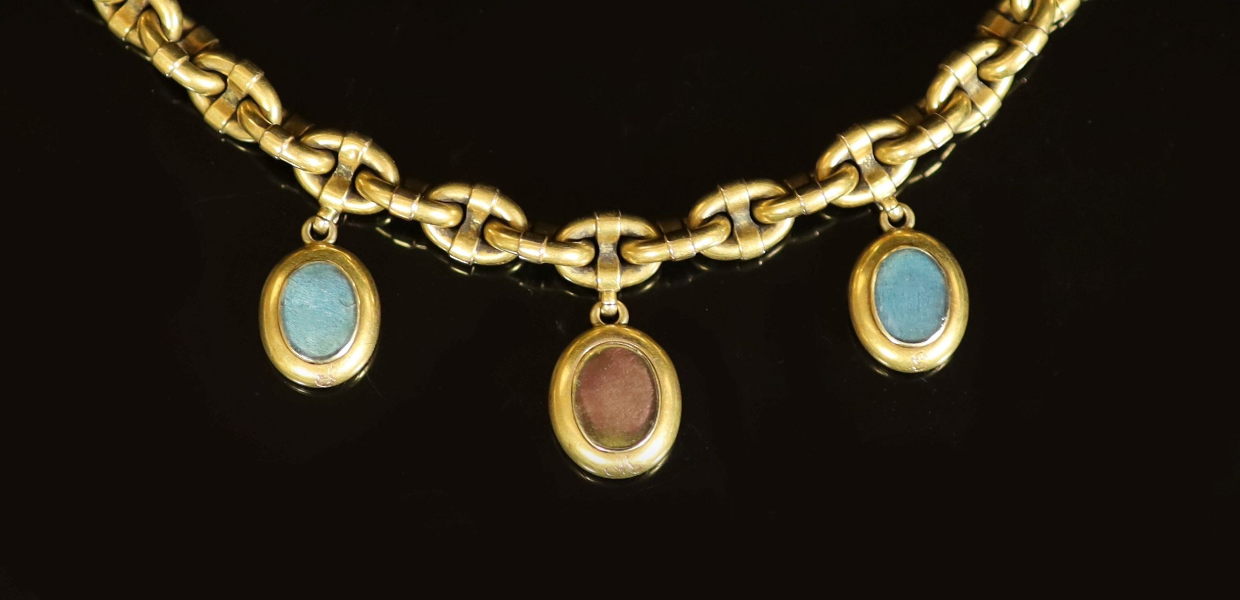 A Victorian gold oval link memorial bracelet, hung with three engraved oval charms, with glazed backs